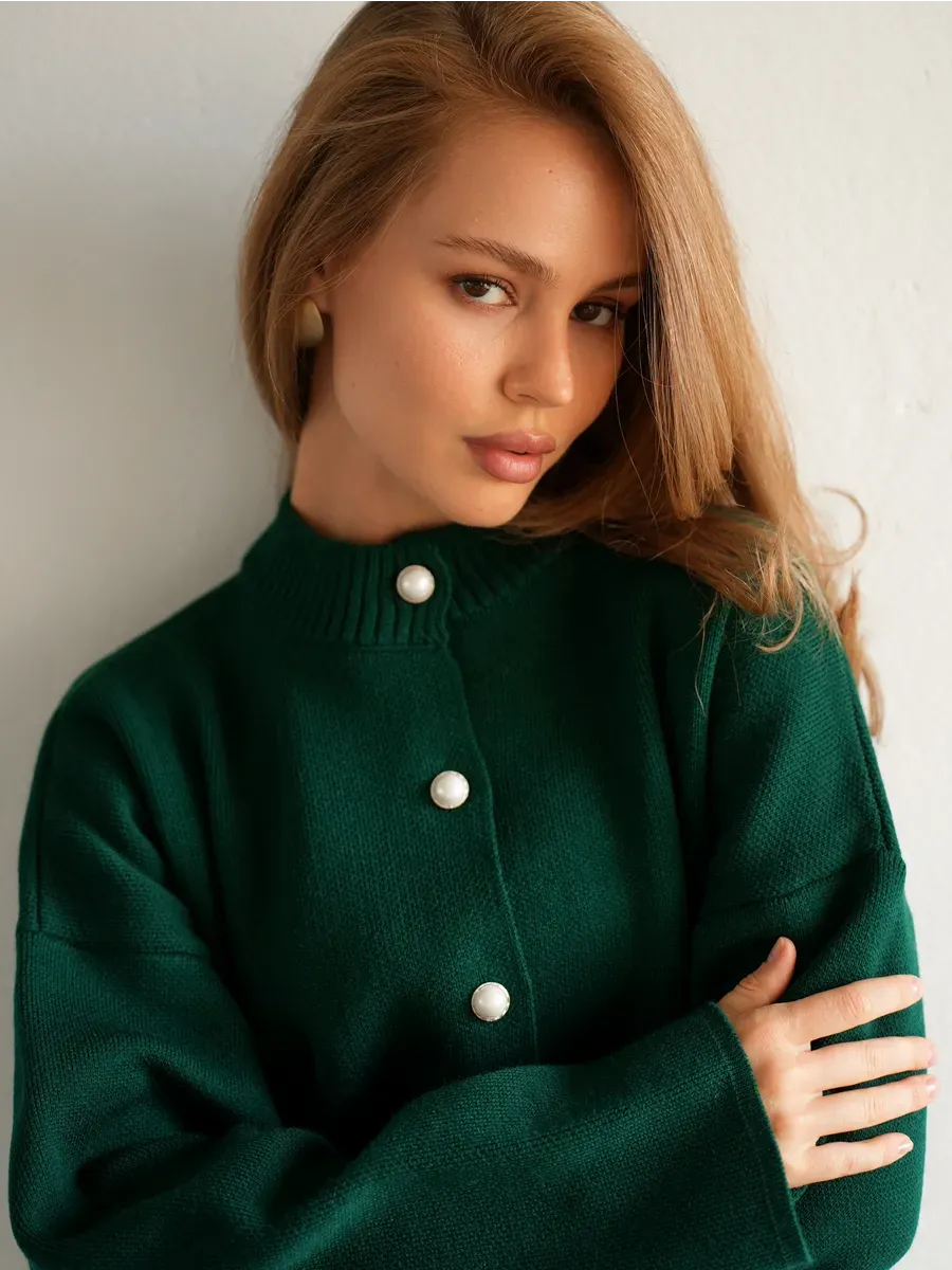 Model wearing a Verdant Cardigan by Lauven in rich emerald green with button closure.