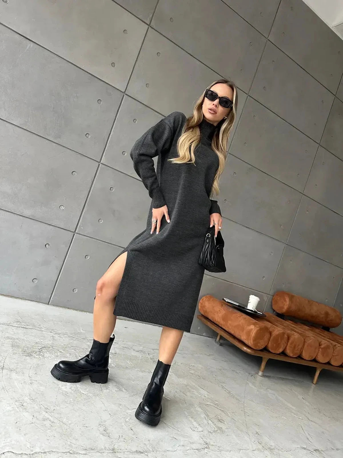 Asteria Midi Dress by Lauven, showcasing cozy knit elegance with a high collar and side slit in a chic setting.