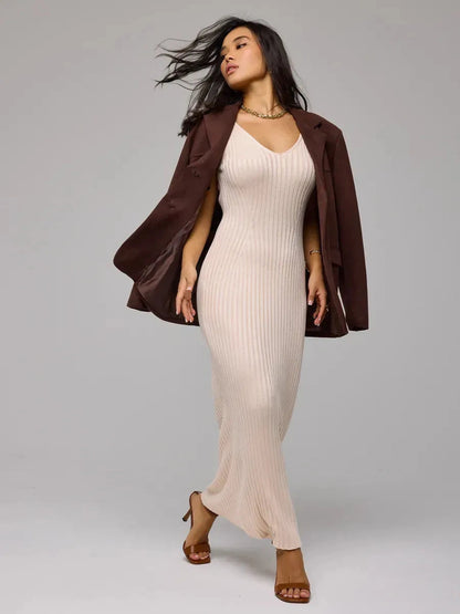 Model wearing Rosette Maxi Dress by Lauven, showcasing its elegant beige ribbed knit design.