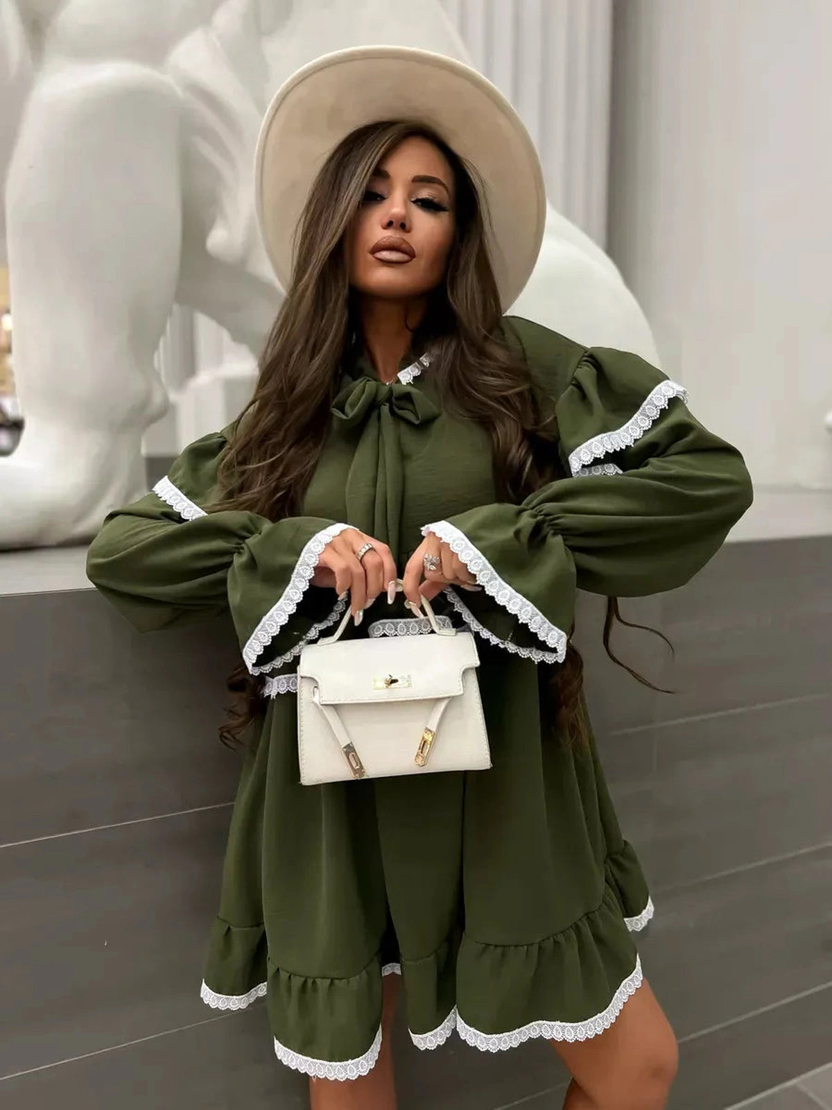 Olivea Mini Dress by Lauven featuring romantic ruffles and lace trim in khaki color, styled with a chic handbag.