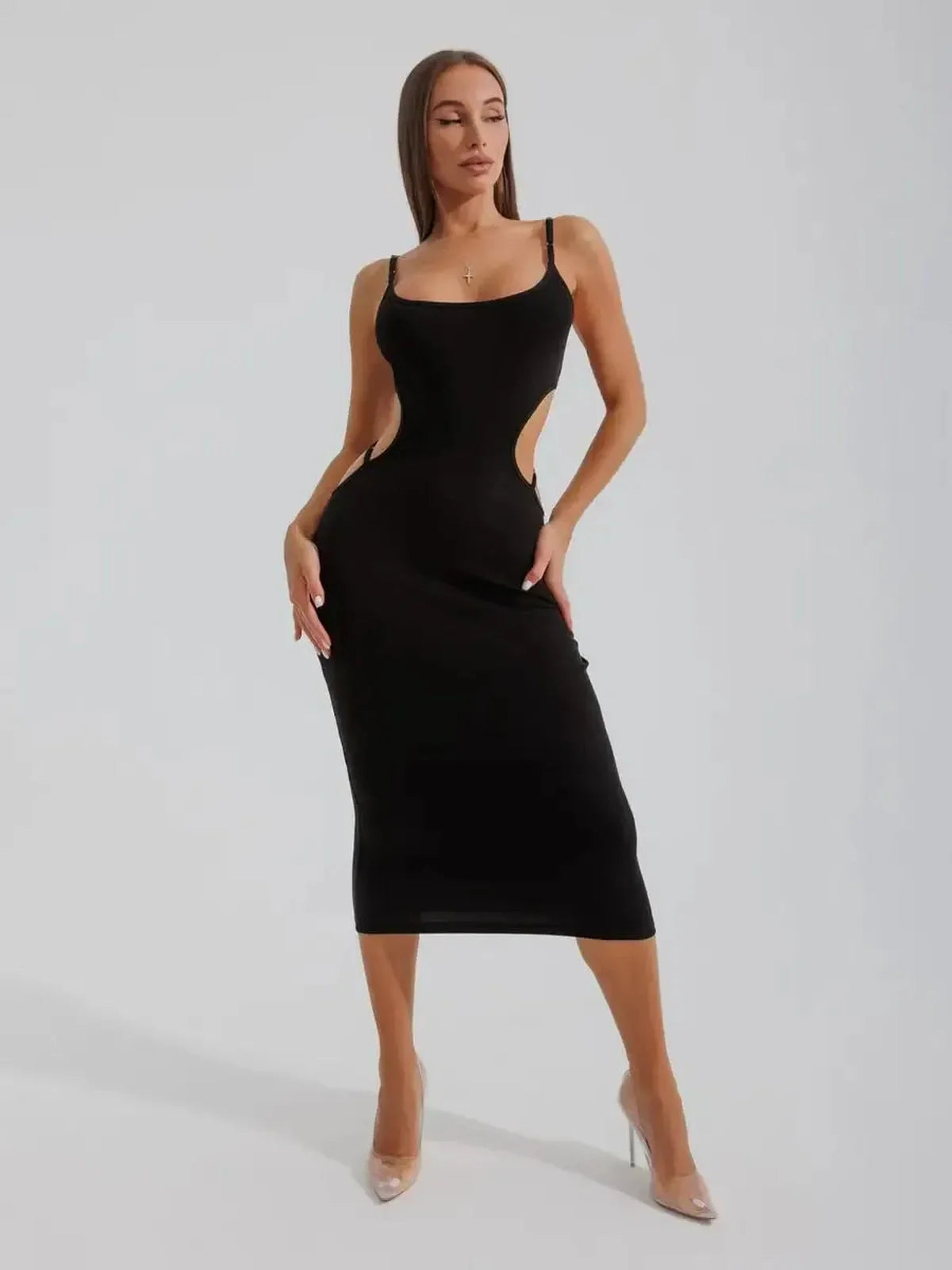 Model showcasing the Midnight Silhouette Midi Dress with curve-hugging cutouts and a sculpted fit.