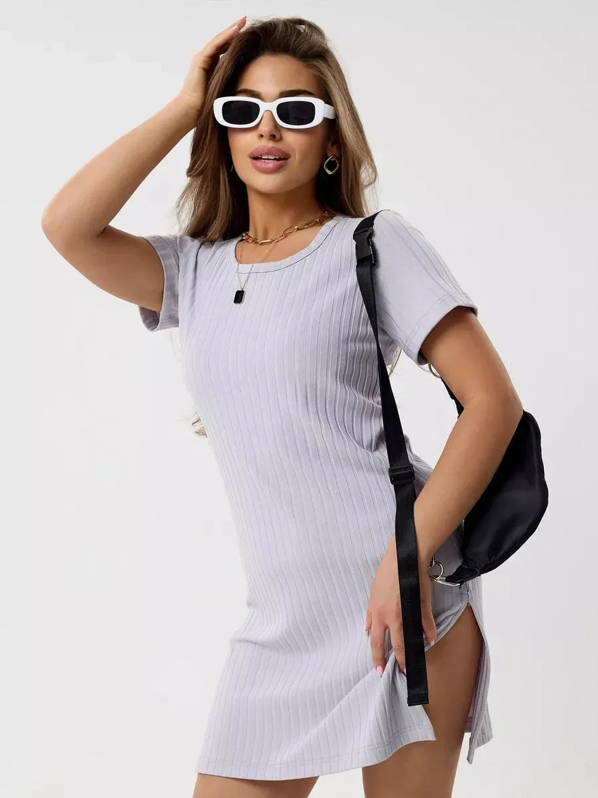 Stylish model wearing a ribbed Cloudline Mini dress with short sleeves and sunglasses, exuding summer vibes.