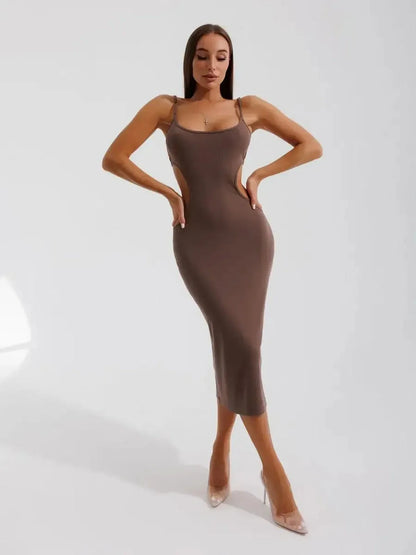Obsidian Curve Midi Dress showcasing sculpting cut-out design and sleek silhouette against a simple backdrop.