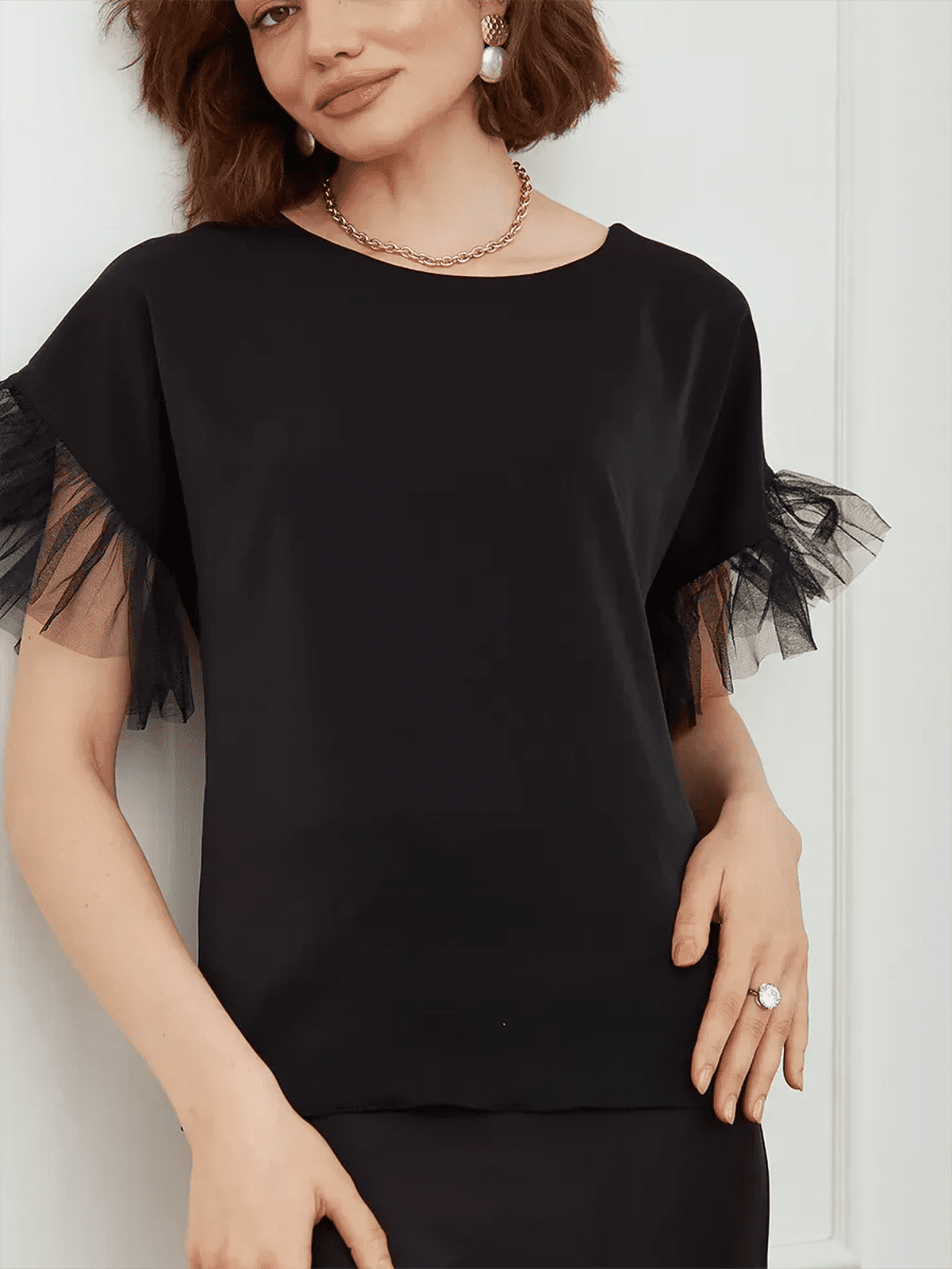 Noiré Blouse - Elegant black blouse with tulle ruffle detail by Lauven, perfect for warm seasons.