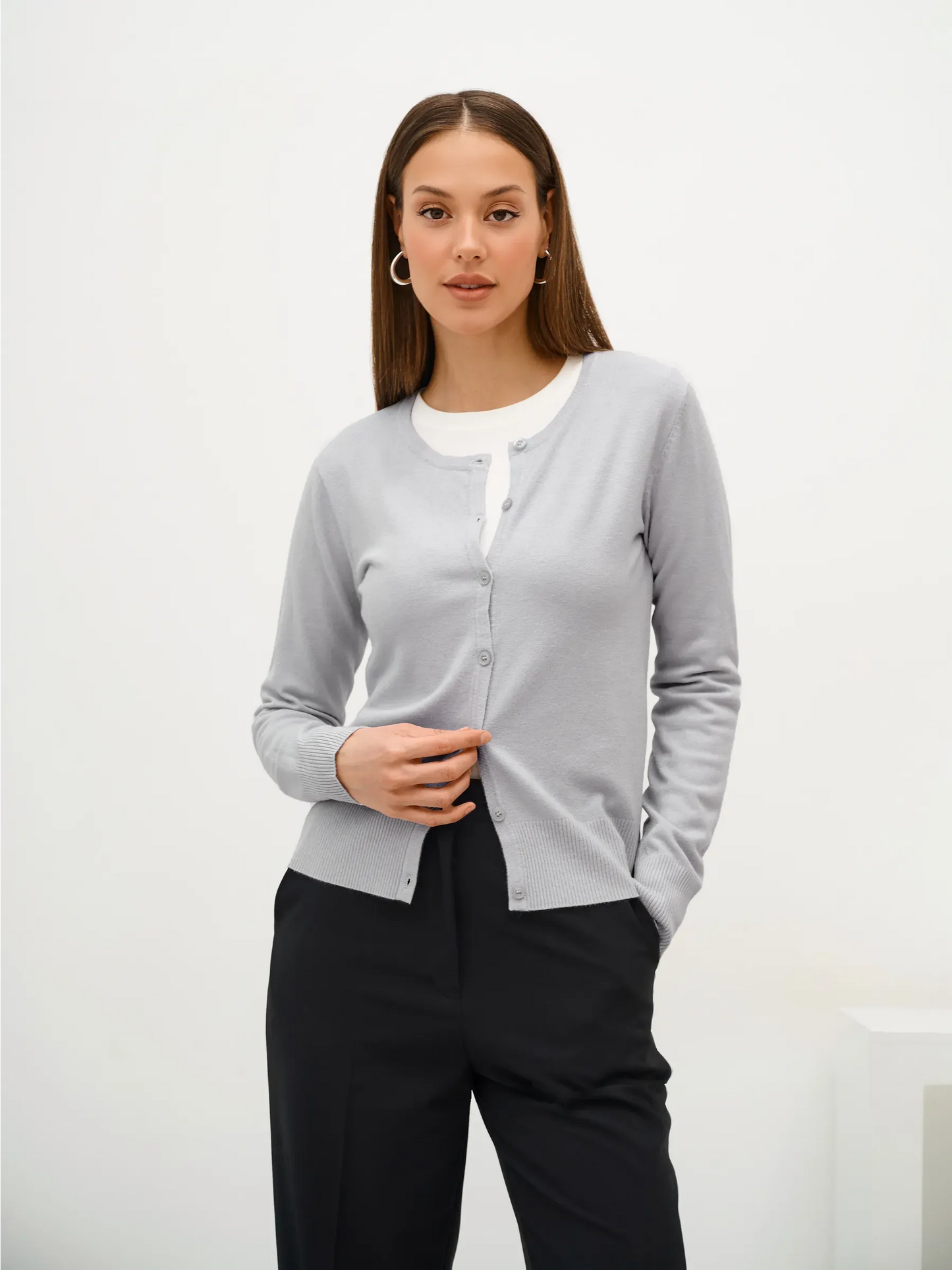 Model wearing Luna Cardigan in soft grey knitwear with classic button closure from Lauven.