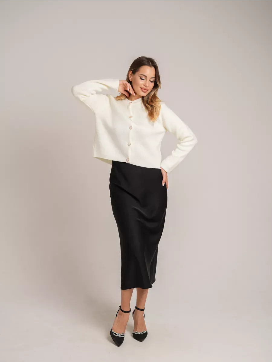 Ivory Cardigan by Lauven, a chic creamy white short knit cardigan with decorative buttons, styled elegantly.