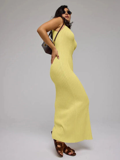 Model wearing the Soleil Maxi Dress by Lauven in elegant yellow ribbed knit, showcasing a modern, chic style.