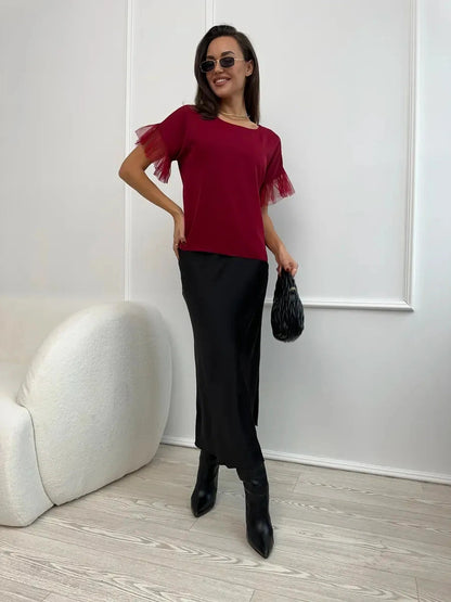 Velora Blouse by Lauven, burgundy short sleeve blouse with sheer ruffle sleeves, styled with a black skirt and accessories.