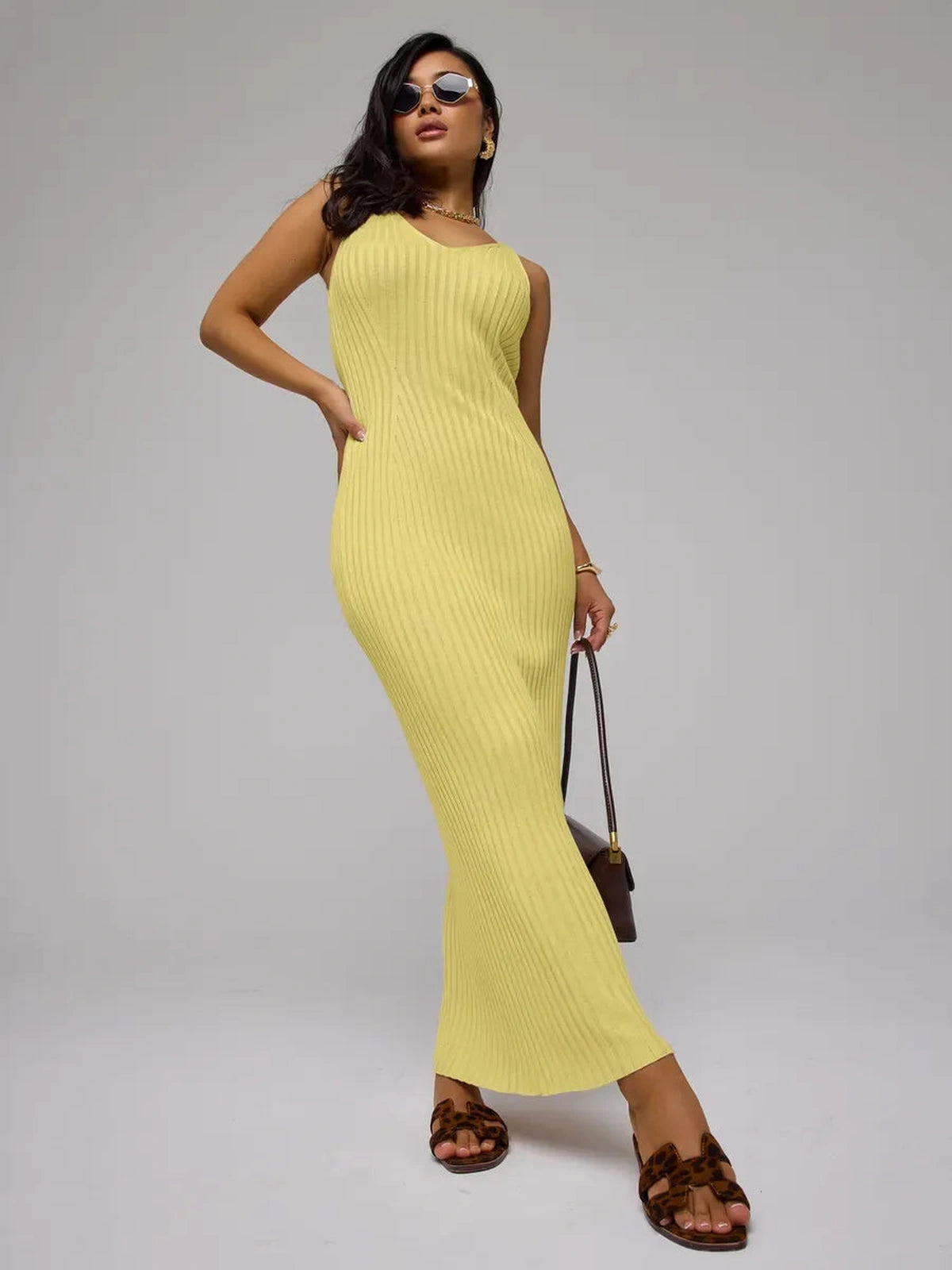 Soleil Maxi Dress by Lauven in vibrant yellow ribbed knit, showcasing a sleek body-hugging silhouette.