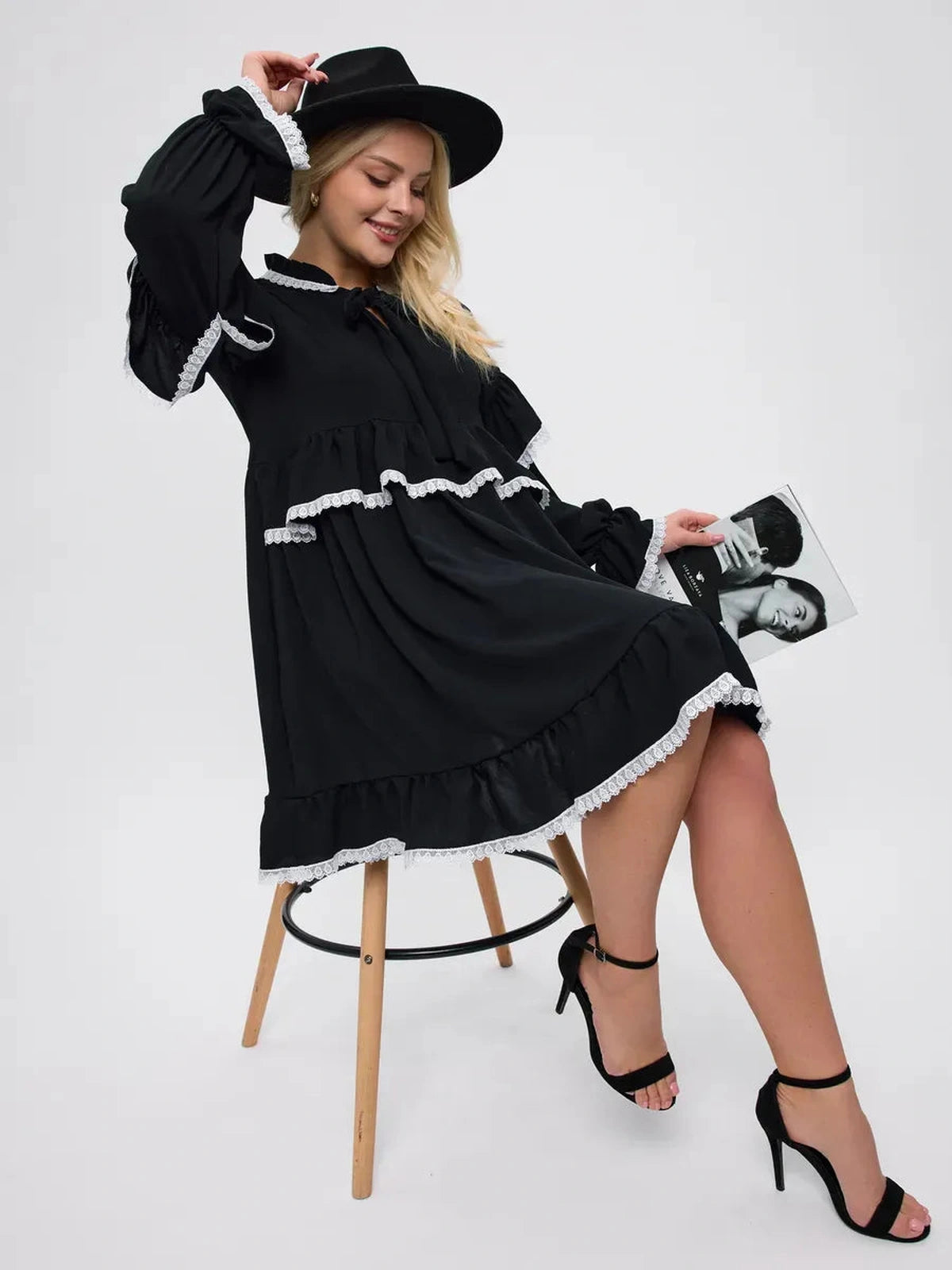 Model wearing the Noiré Mini Dress by Lauven, featuring elegant ruffles and delicate lace trim.