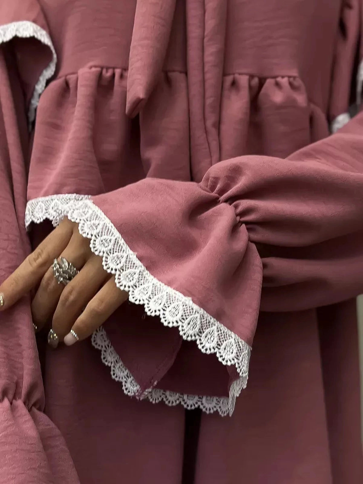 Close-up of Rosea Mini Dress featuring elegant ruffles and lace detail by Lauven, showcasing feminine sophistication.