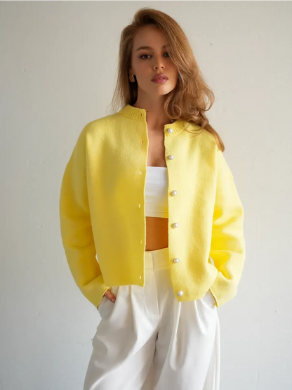 Model wearing a warm yellow Lemonade Cardigan by Lauven with button closure, styled for a chic look.