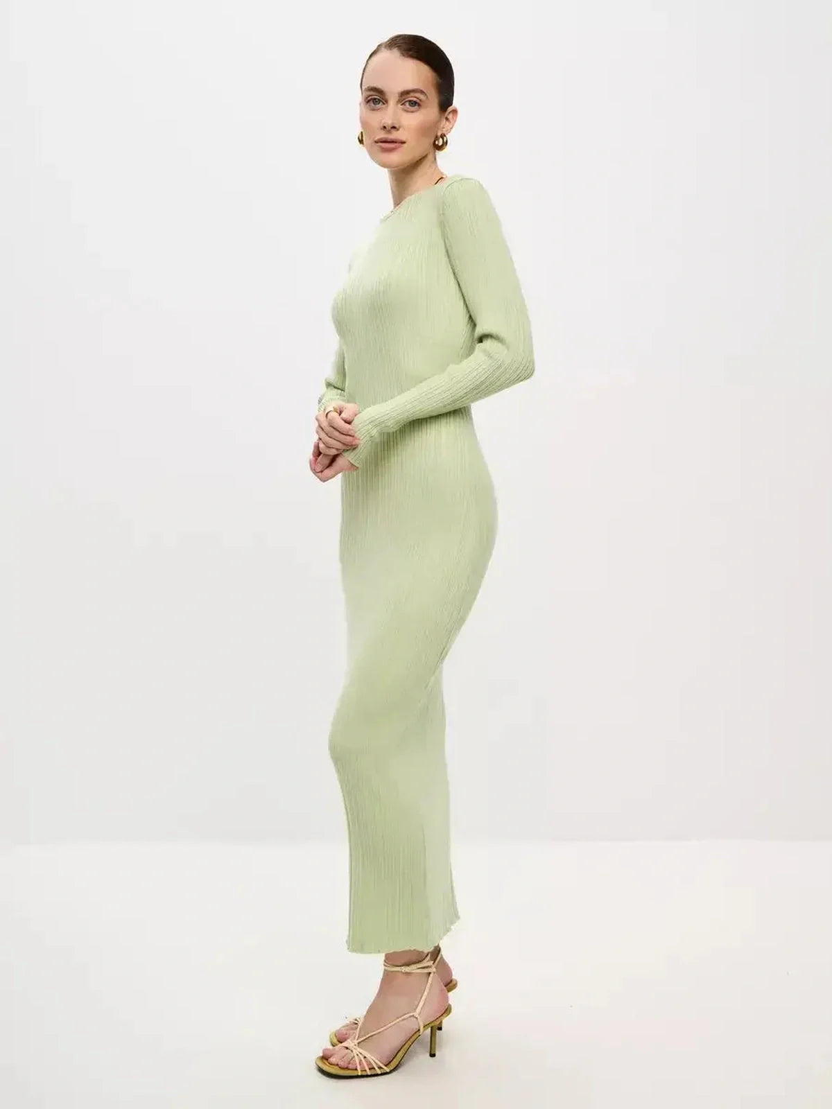 Model wearing the Celery Luxe Maxi Dress in light green, showcasing its sculpted ribbed fit and seamless elegance.