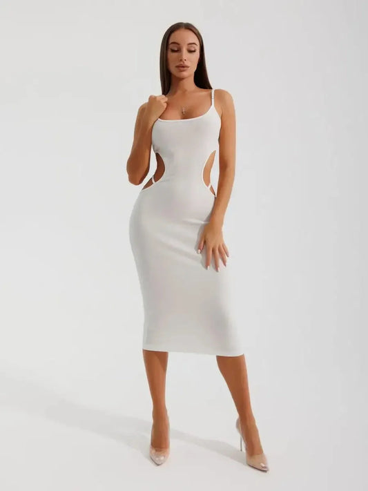 Model in a white midi dress with cutouts, showcasing a sleek silhouette and elegant design.