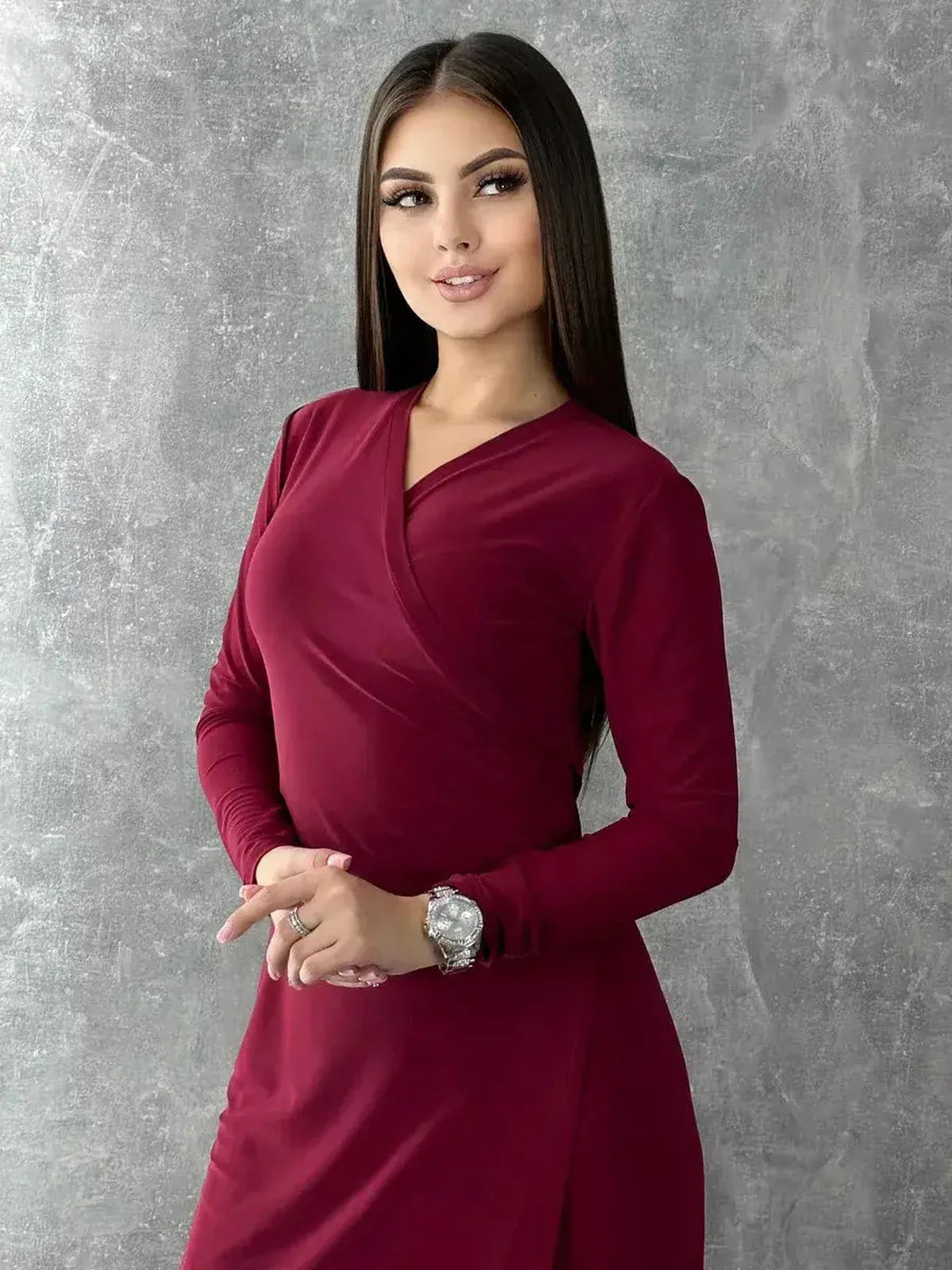 Elegant woman in a burgundy wrap maxi dress with V-neck and long sleeves, showcasing a refined silhouette.
