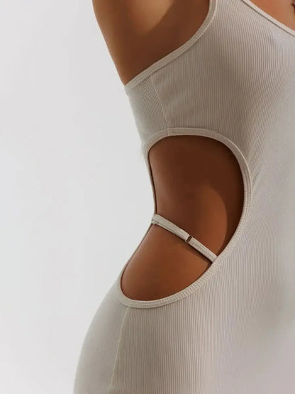 Close-up of Midi Dress Seraphine showing sculptural side cutouts and a bodycon fit in beige ribbed knit.