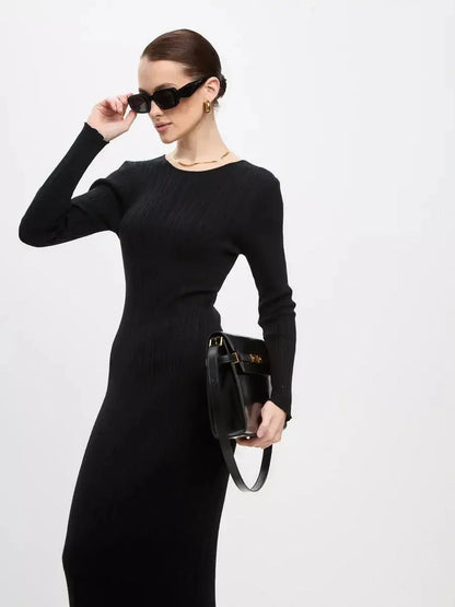 Chic model in Sculpted Rib Maxi Dress, showcasing streamlined silhouette and subtle ribbed texture for versatile styling.
