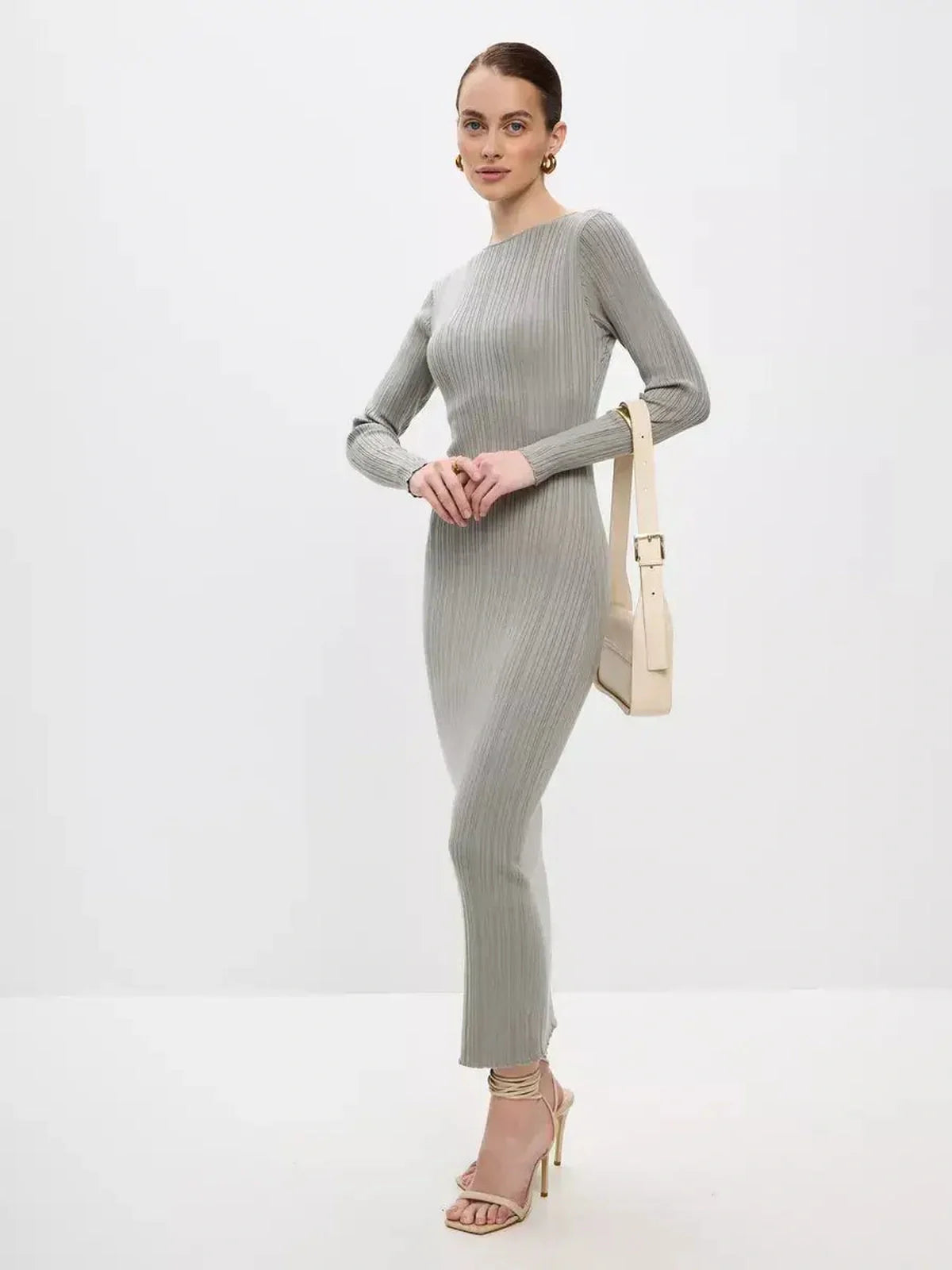 Model showcasing the Sculpted Grace Maxi Dress in ribbed knit, exuding elegance and sophistication.