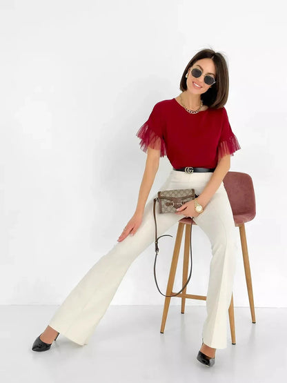 Velora Blouse by Lauven, burgundy short sleeve blouse with sheer ruffle sleeves, styled with white pants and accessories.