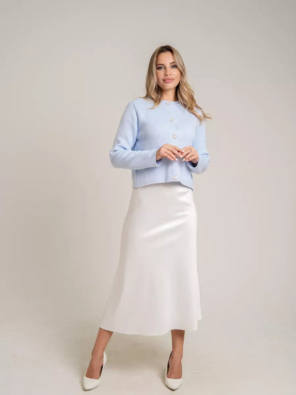 Celeste Cardigan by Lauven in light blue, featuring decorative buttons, styled with a satin skirt.