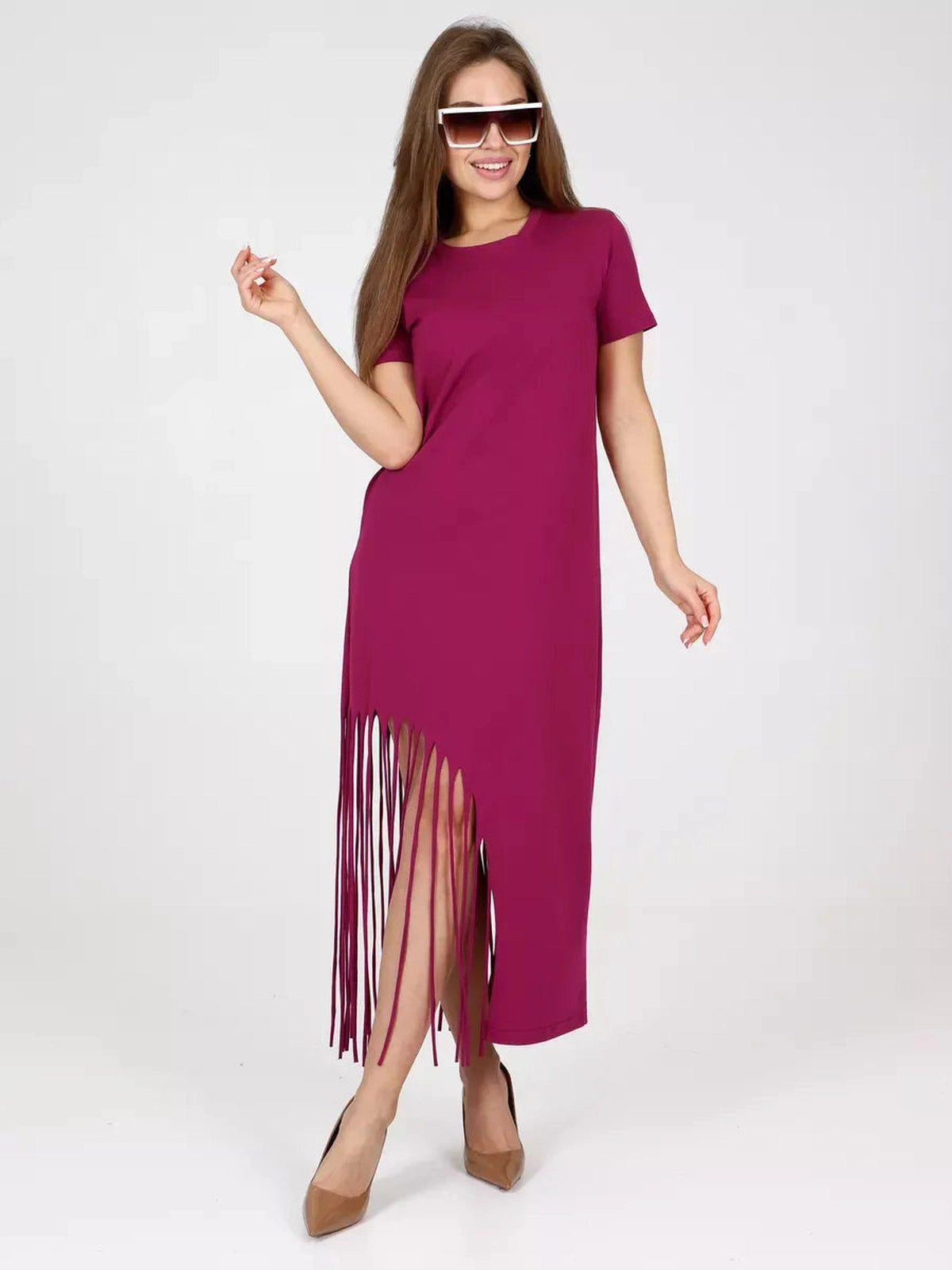 Model showcasing the Riviera Midi Dress by Lauven, featuring fringe hem and relaxed fit in vibrant magenta.