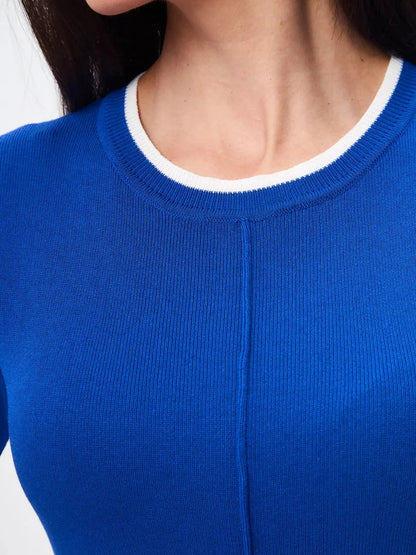 Close-up of Asteria Mini Dress by Lauven, featuring vibrant blue knit with refined white contrast trim.