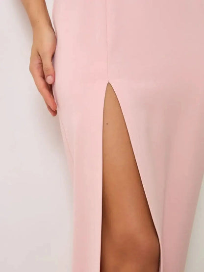Close-up of the front slit on the Celestia Maxi Dress by Lauven in soft powder pink.