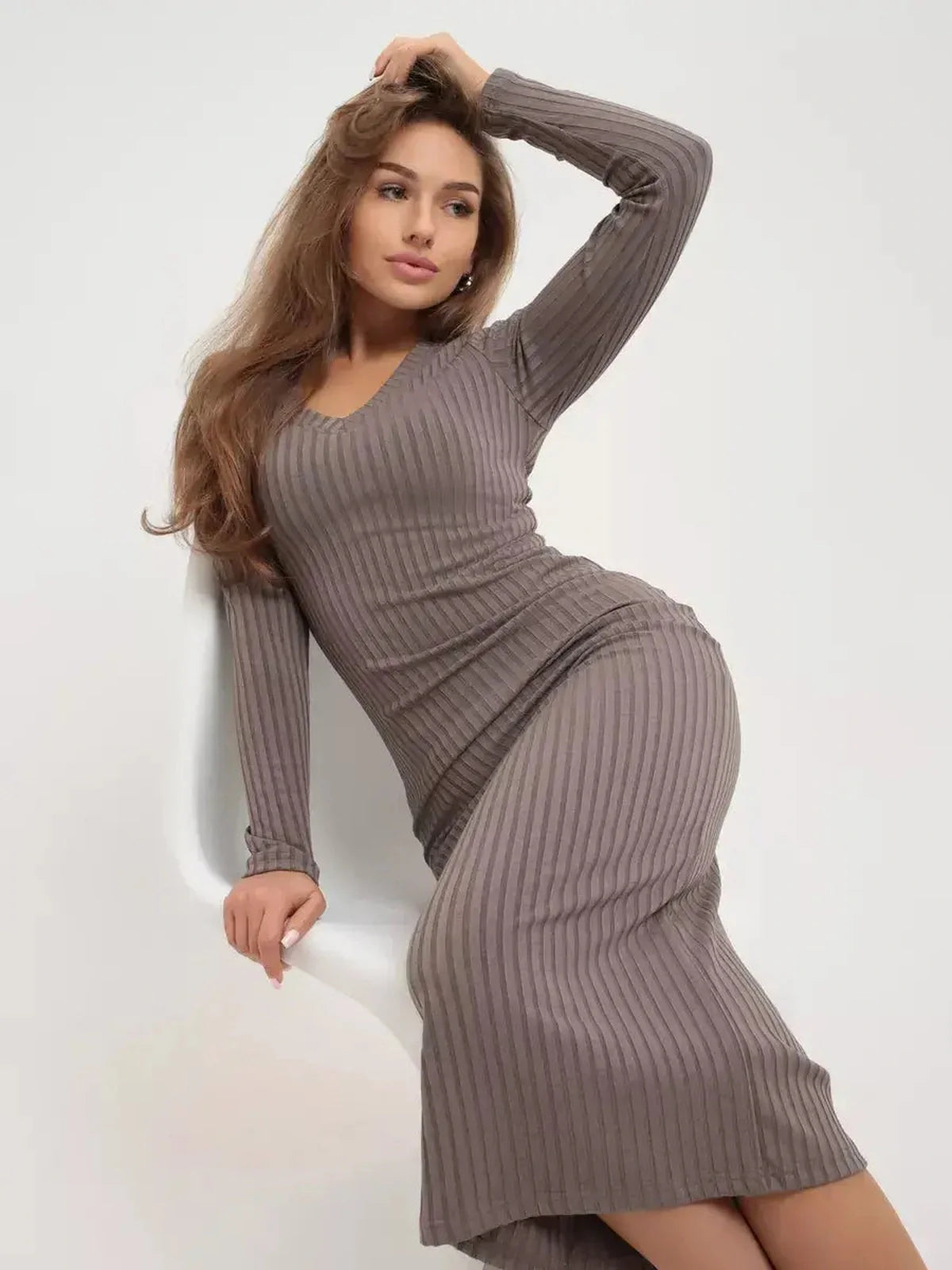 Stylish woman in a ribbed contour midi dress, showcasing a sleek silhouette and comfortable fit.