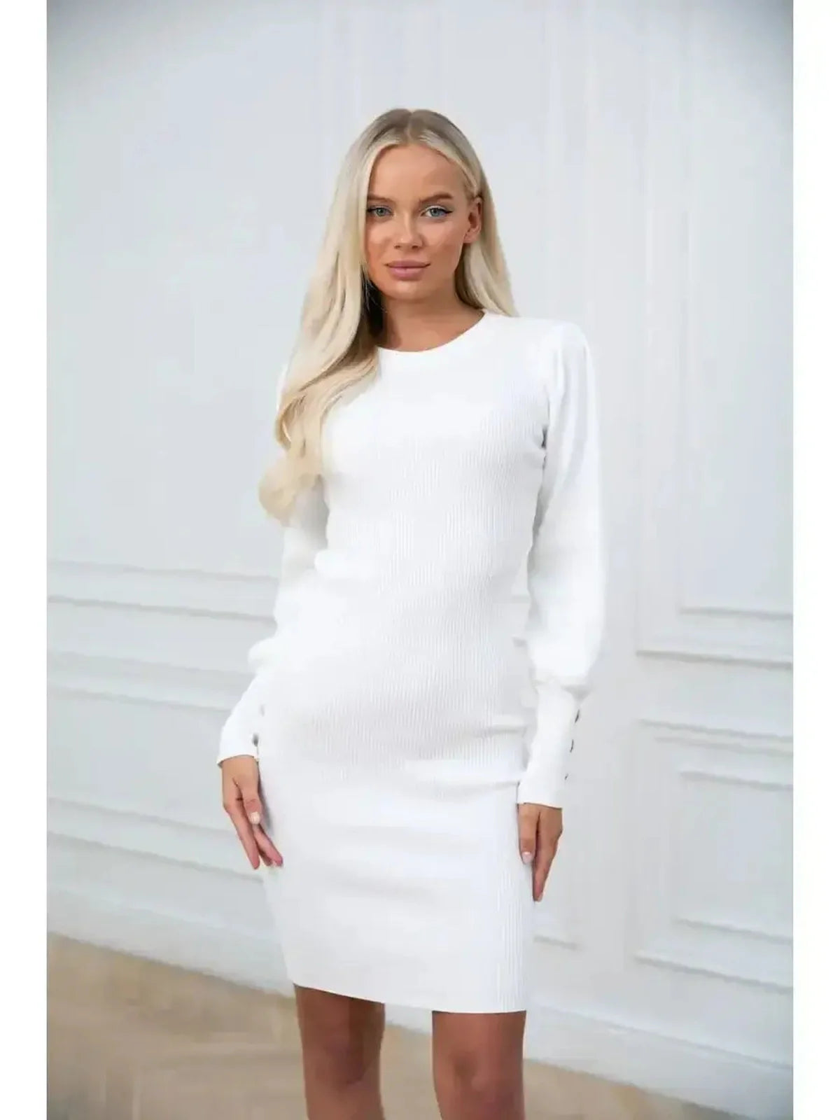 Ivory Curve white knit mini dress with long sleeves and structured cuffs, showcasing elegant and modern design.