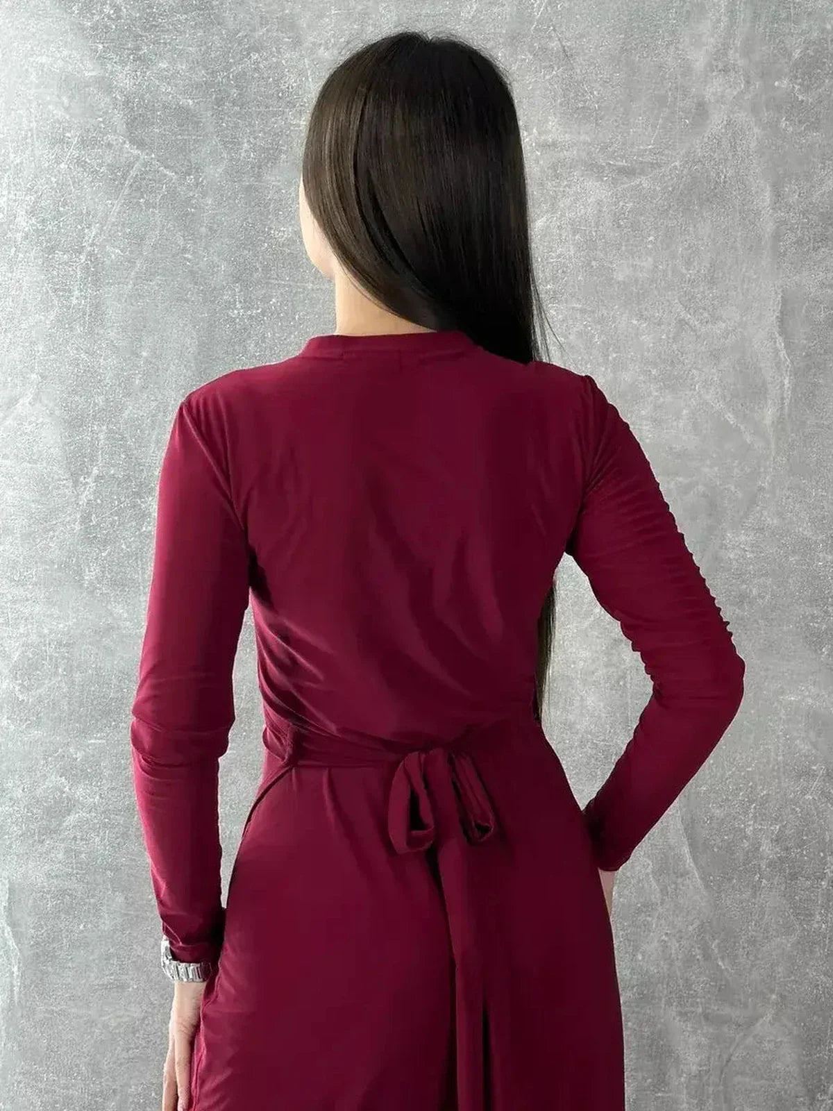 Back view of the Crimson Grace Maxi Dress in burgundy, showcasing its elegant wrap style and adjustable tie waist.