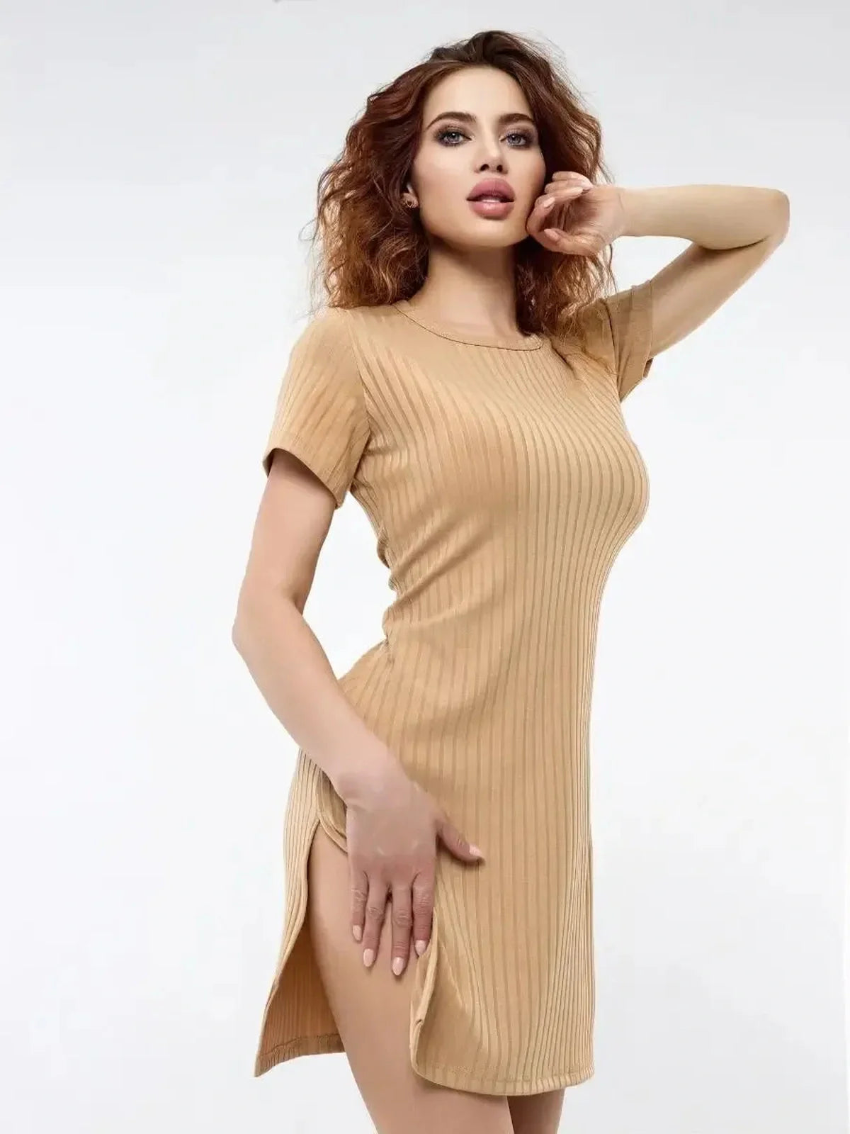 Model showcasing the Soft Edge mini dress, featuring ribbed knit, short sleeves, and bold side slits for a summer look.