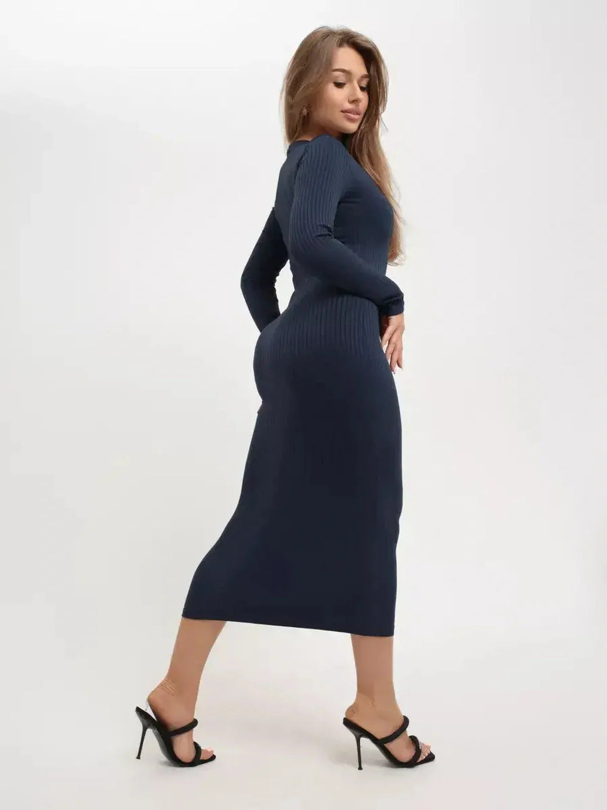 Model showcasing a dark navy ribbed Contour Midi Dress with long sleeves, perfect for elegant occasions.