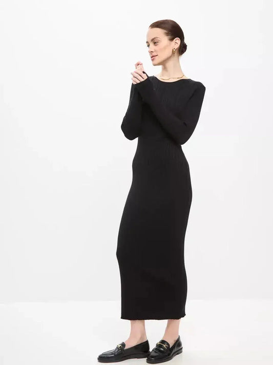 Model wearing a Sculpted Rib Maxi Dress in black, showcasing a streamlined silhouette and elegant design with long sleeves.
