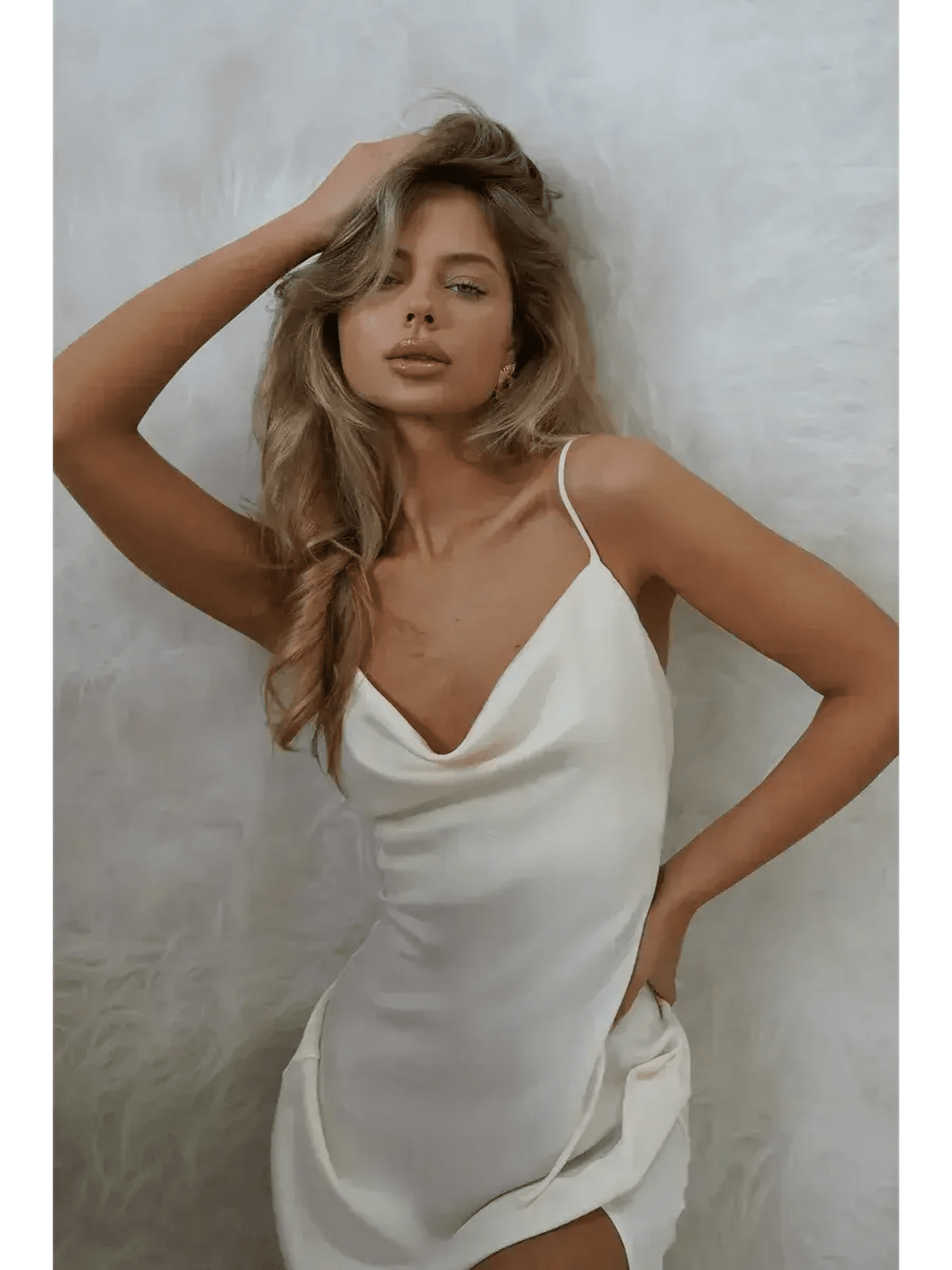 Model wearing an Ivory Luxe Maxi Dress with silky drape and side slit, showcasing elegant summer fashion.