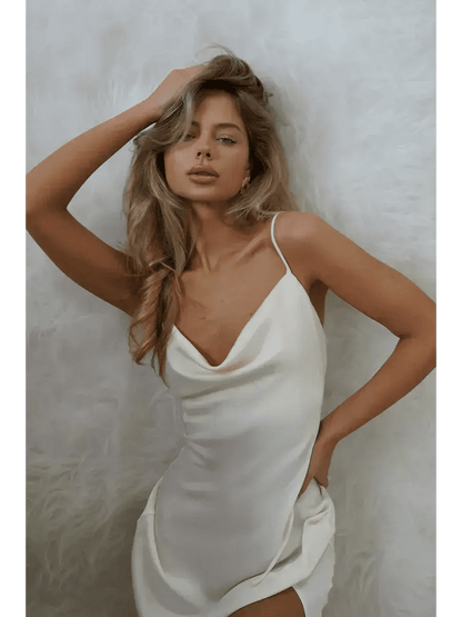 Model wearing an Ivory Luxe Maxi Dress with silky drape and side slit, showcasing elegant summer fashion.