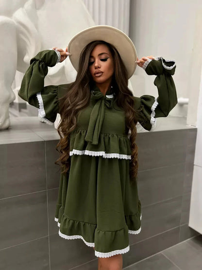 Olivea Mini Dress by Lauven in khaki with ruffles and lace trim, featuring an oversized fit and stylish hat.