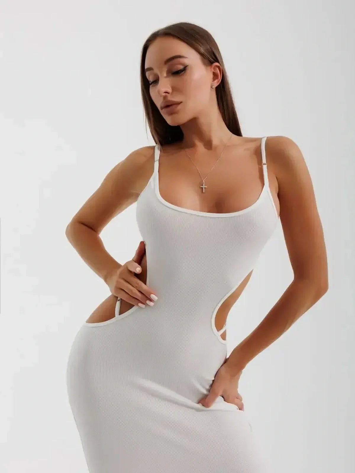 Model showcasing the Midi Dress Cutout Muse, featuring a sleek silhouette and alluring side cutouts in a textured rib knit.