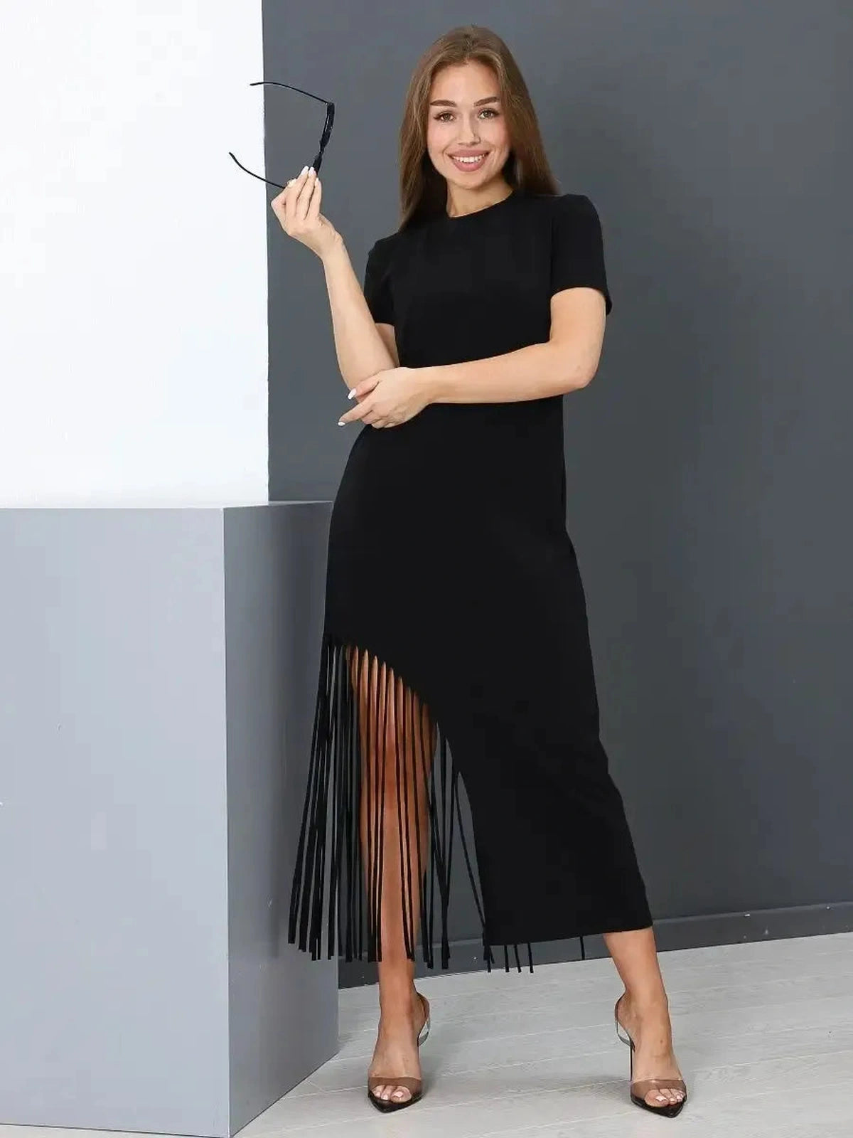 Noir Midi Dress by Lauven, featuring a chic black design with fringe hem for a modern, elegant look.