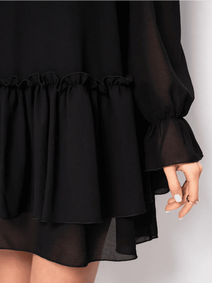 Detail of the Noirelle Mini Dress by Lauven, showcasing ruffled layers and elegant black chiffon fabric.