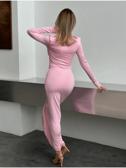 Model showcasing the Blush Muse Maxi Dress from the back, featuring a sleek silhouette in soft pink fabric.