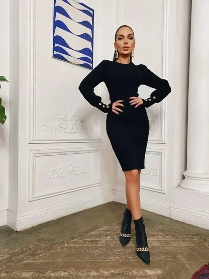 Model wearing a refined black mini dress with long sleeves and gold-tone button details, showcasing elegant style.