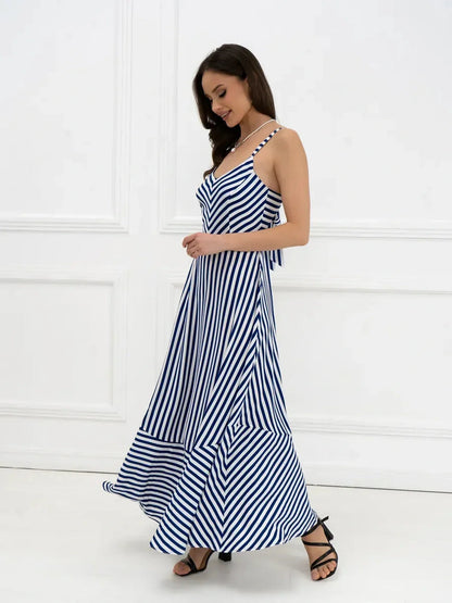 Marina Stripe Maxi Dress in navy and white stripes, featuring a flowing silhouette and open-back bow detail.