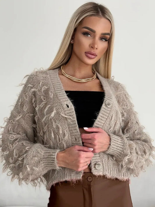 Sahara Cardigan by Lauven, cropped oversized beige bouclé knit with feathered fringe details.