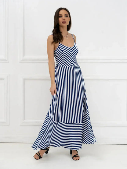 Model wearing a stylish Marina Stripe Maxi Dress with bold stripes, perfect for summer outings and seaside events.