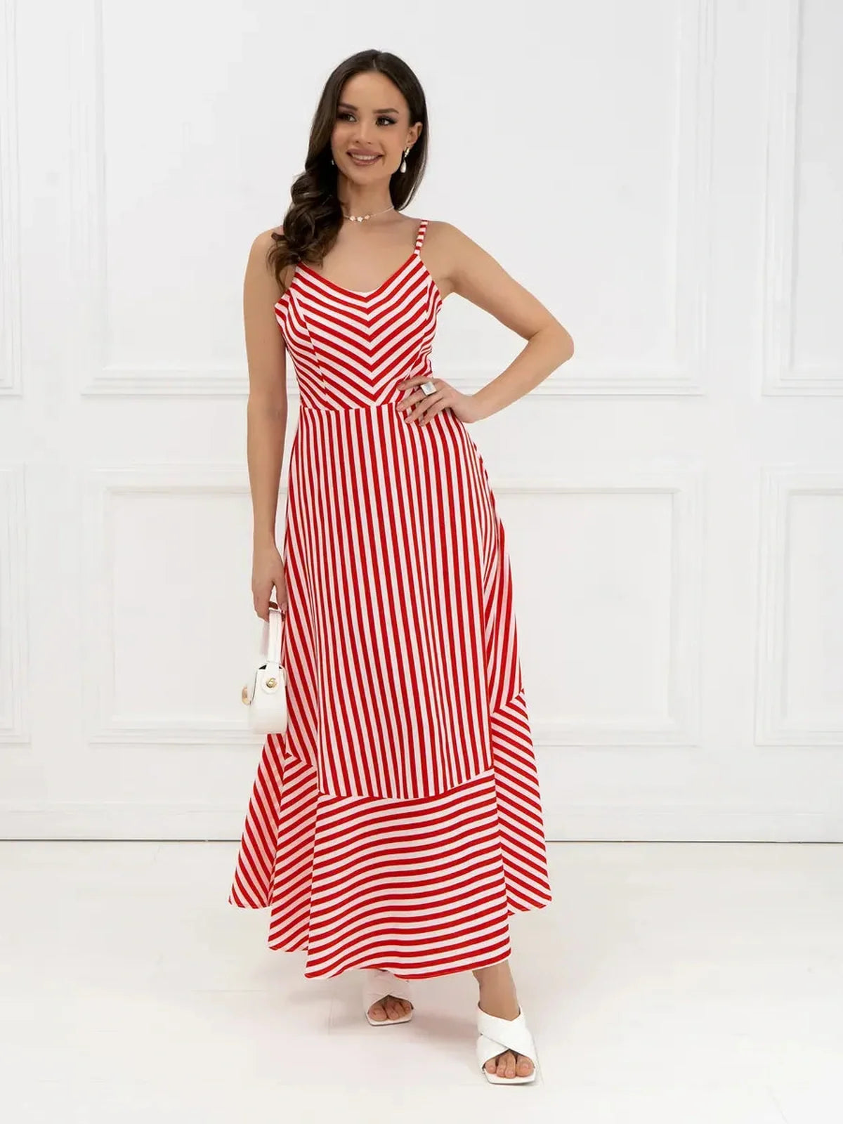 Maxi Dress Riviera Curve featuring bold red-and-white stripes, elegant chevron pattern, and playful back bow tie.