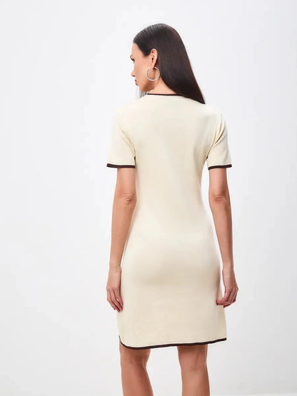 Back view of Marbella Mini Dress by Lauven, showcasing its soft neutral tones and refined A-line silhouette.