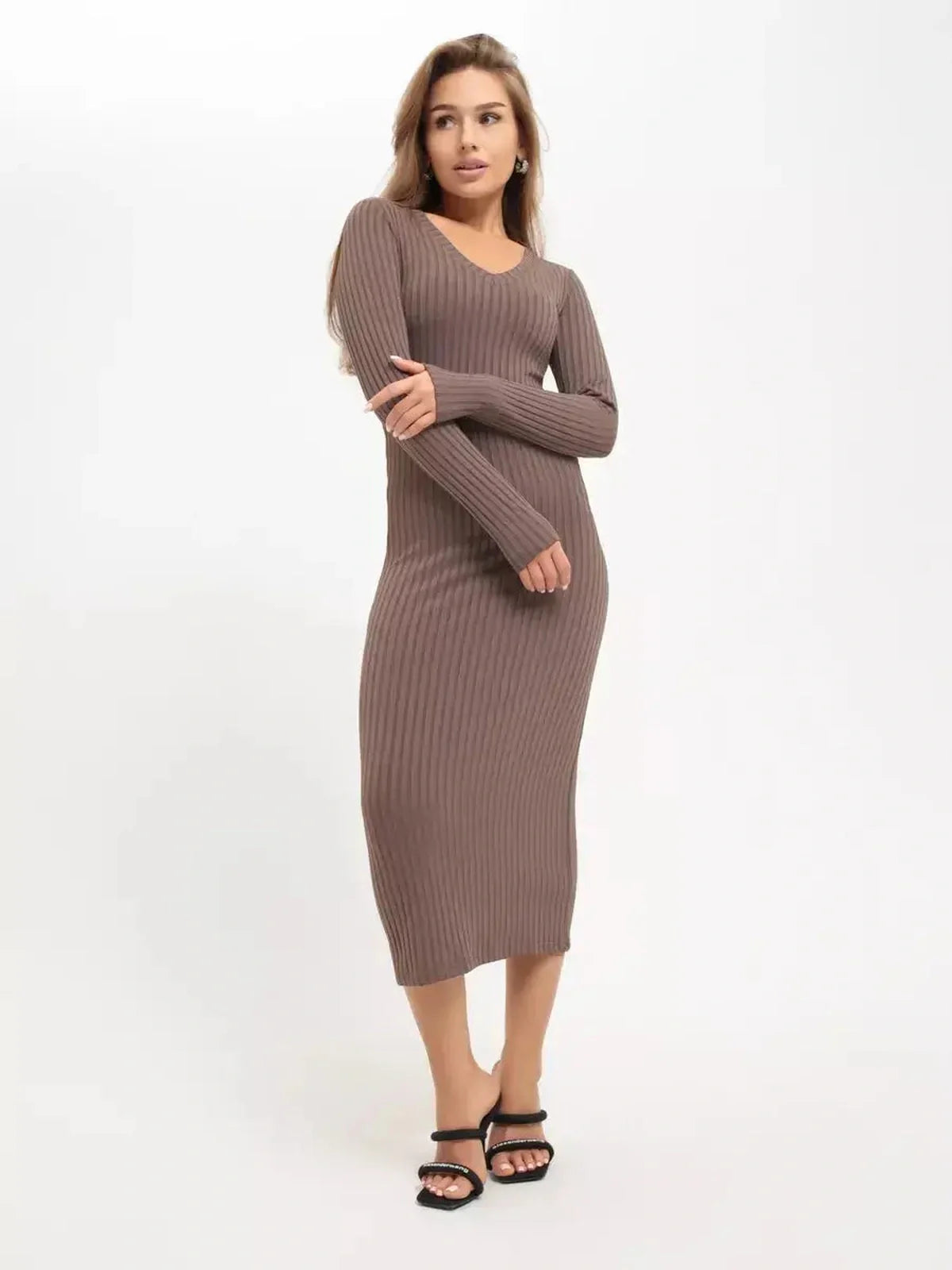 Model wearing a sleek ribbed Contour Midi Dress in a neutral tone, showcasing its sculpted fit and elegant silhouette.