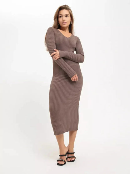 Model wearing a sleek ribbed Contour Midi Dress in a neutral tone, showcasing its sculpted fit and elegant silhouette.