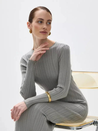 Model showcasing the Sculpted Grace Maxi Dress in soft ribbed knit, emphasizing elegance and minimalist design.
