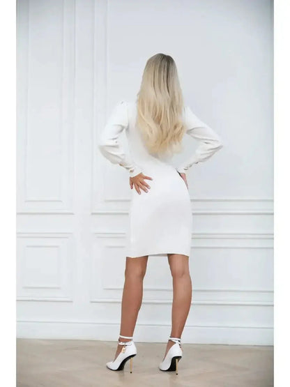 Back view of a woman in an ivory curve mini dress with voluminous sleeves and high-fashion heels.